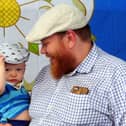 Happy Yorkshire Day - Father and son celebrate the day at Kirkgate Market, Leeds, sporting traditional flat caps