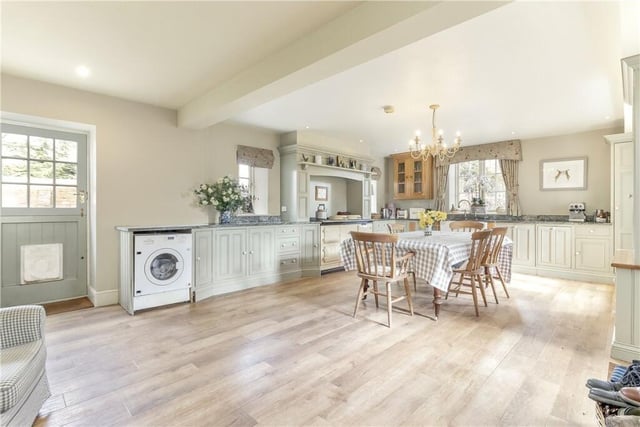 The beamed breakfast kitchen with fitted units and an Aga is light and airy.