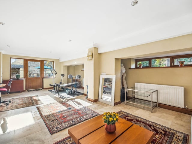Flexible living space used here as a home gym, office and seating areas.