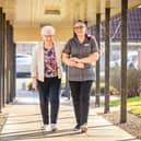 Resident and care home colleague taking a walk outside HC-One care home