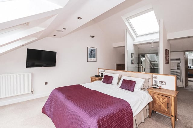 Upstairs, the principal suite boasts a impressive views through six large Velux windows.