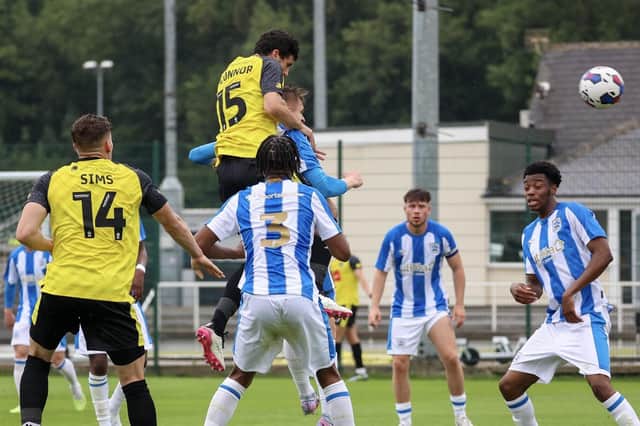 Anthony O'Connor climbs highest to head home Harrogate Town's winning goal in Saturday's pre-season friendly win over Huddersfield Town 'B'. Pictures: Matt Kirkham