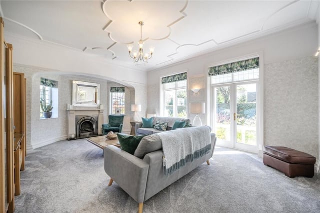 A double aspect reception room with feature fireplace and doors out to the garden.