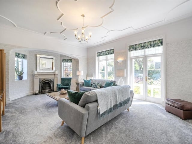 A double aspect reception room with feature fireplace and doors out to the garden.