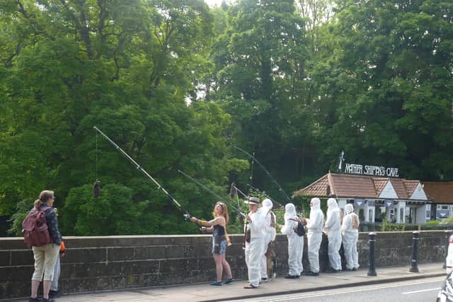 Protest over sewage discharges in the River Nidd - Extinction Rebellion Harrogate activists dressed in white overalls at the High Bridge in Knaresborough on Saturday. (Picture contributed)