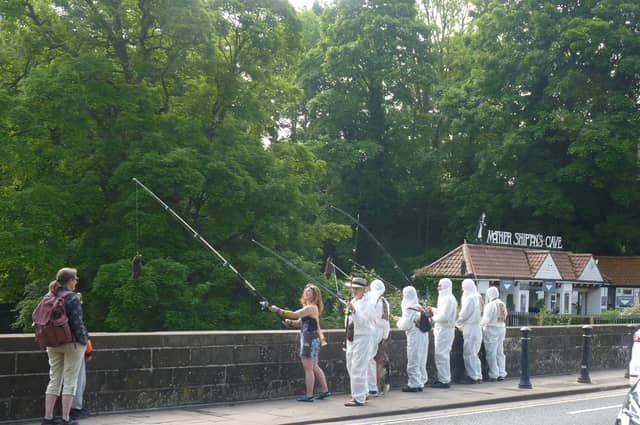 Protest over sewage discharges in the River Nidd - Extinction Rebellion Harrogate activists dressed in white overalls at the High Bridge in Knaresborough on Saturday. (Picture contributed)