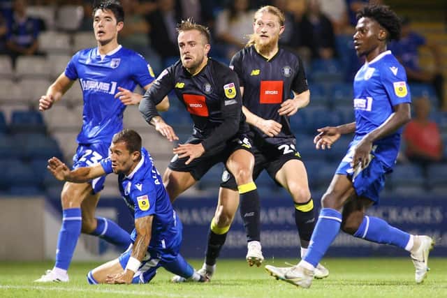 Alex Pattison fires Harrogate Town into a 2-0 lead during Tuesday night's League Two clash at Gillingham.