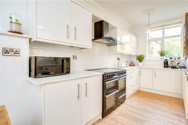 A contemporary style kitchen with fitted units and quartzite worktops, includes a Rangemaster cooker.