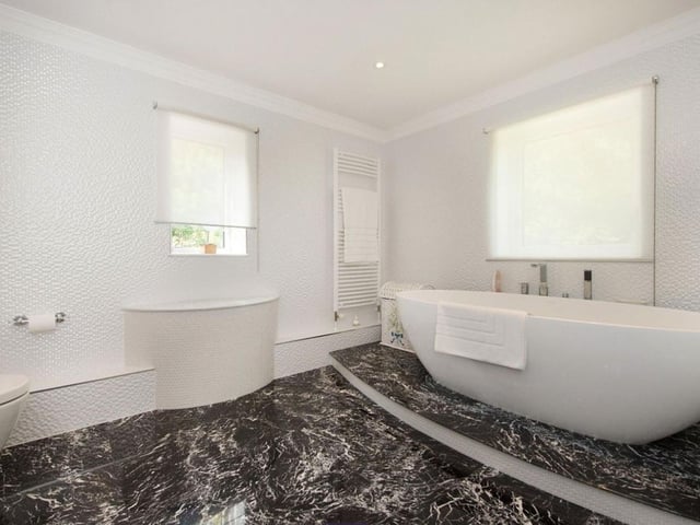 The master bathroom complete with its stylishly designed bath suite.