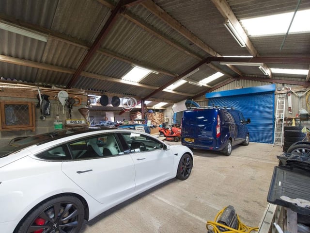 The property has a substantial garage and workshop space.
