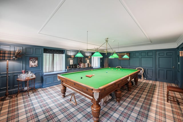 The impressive snooker room with panelled walls.