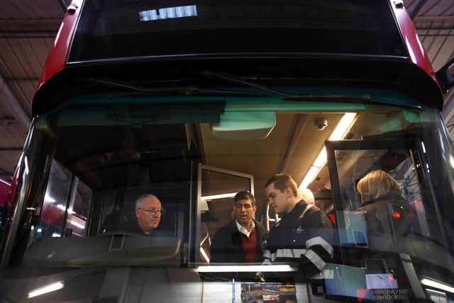 Prime Minister Rishi Sunak gets a closer look at one of the buses. Photo: Getty Images
