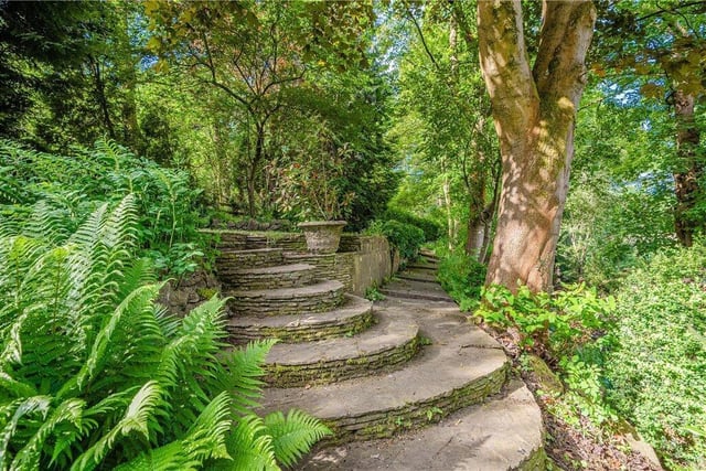Garden pathways go through woodland-type terrain.
