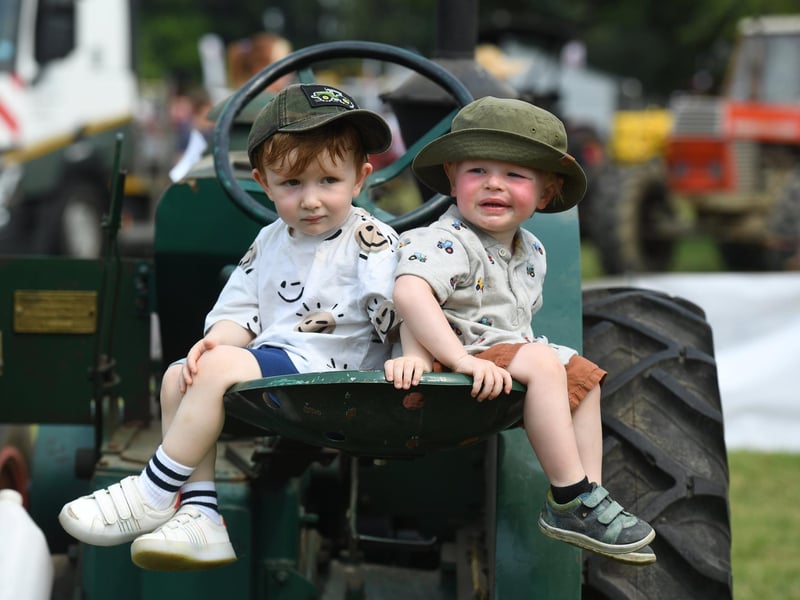 Sam Chapman (aged two) and Archie Kitching (aged two) sat on the tractors in the sunshine at Newby Hall