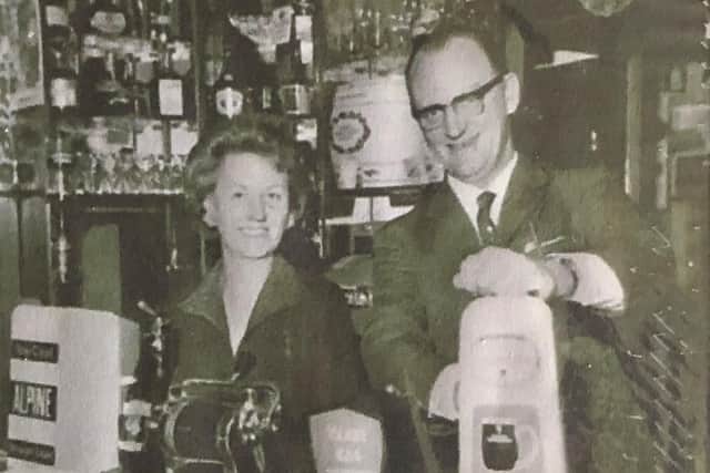 Anne Sames and her husband Geoff behind the bar at their pub, The Ridgewood, in the 1960s.