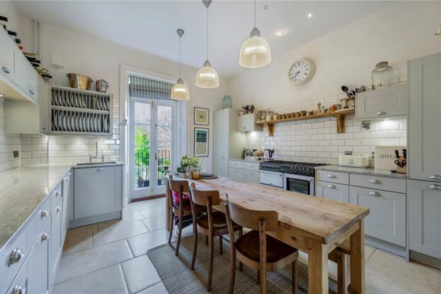 The breakfast kitchen is fitted with shaker-style cabinets and has doors out to a balcony.