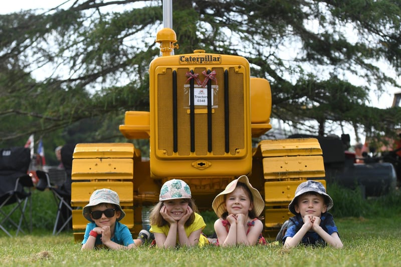 Finn Allinson (aged five), Rebecca Richards (aged 7), Jessica Richards (aged 6) and Leo Allinson (aged 7) with a Caterpillar Tractor