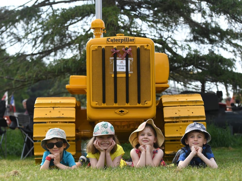 Finn Allinson (aged five), Rebecca Richards (aged 7), Jessica Richards (aged 6) and Leo Allinson (aged 7) with a Caterpillar Tractor