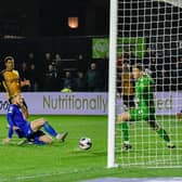 Luke Armstrong slides in to net his 16th goal of the season in the 83rd minute of Harrogate Town's 3-2 win at Newport County. Pictures: Harrogate Town AFC