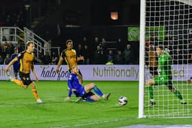 Luke Armstrong slides in to net his 16th goal of the season in the 83rd minute of Harrogate Town's 3-2 win at Newport County. Pictures: Harrogate Town AFC