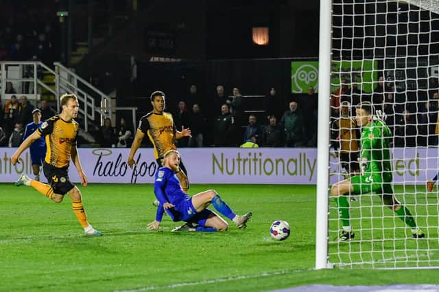 Luke Armstrong slides in to net his 16th goal of the season in the 83rd minute of Harrogate Town's 3-2 win at Newport County. Pictures: Harrogate Town AFC