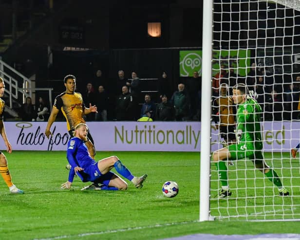 Luke Armstrong slides in to net his 16th goal of the season in the 83rd minute of Harrogate Town's 3-2 win at Newport County. Pictures: Harrogate Town AFC