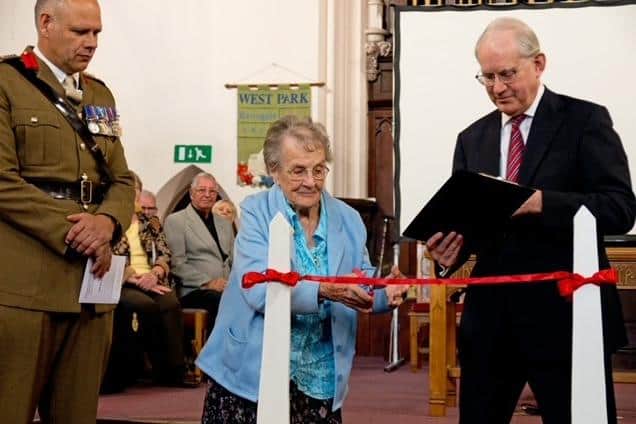 Harrogate's remarkable Sheila Pantin cutting the ribbon of the More than a Name on a Memorial exhibition flanked by Colonel Nigel Rhodes Royal Yorkshire Regiment and Nigel McClea, chairman of Harrogate War Memorial Project Group.  (Picture contributed)