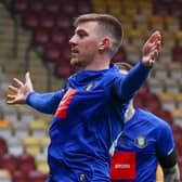 Matty Daly celebrates in front of the Bradford City supporters after firing Harrogate Town into an early lead at Valley Parade. Pictures: Matt Kirkham