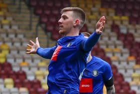 Matty Daly celebrates in front of the Bradford City supporters after firing Harrogate Town into an early lead at Valley Parade. Pictures: Matt Kirkham