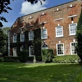 The previous look of the exterior included moss covering the brick building.