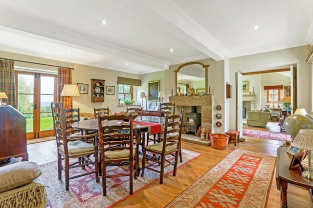 The dining room, with stone fireplace and log burner, also has access to the gardens.