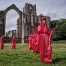 Surprise protest at historic site near Ripon - A procession by ‘The Red Rebels’ of Extinction Rebellion at Fountains Abbey on Saturday. (Picture Gerard Liston )