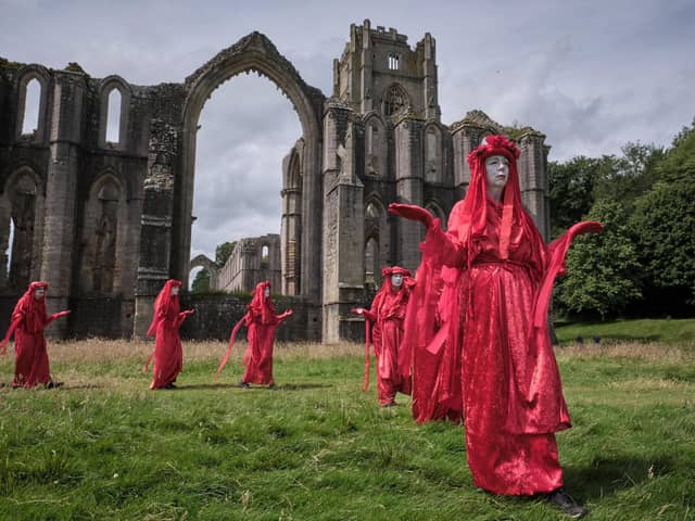 Surprise protest at historic site near Ripon - A procession by ‘The Red Rebels’ of Extinction Rebellion at Fountains Abbey on Saturday. (Picture Gerard Liston )