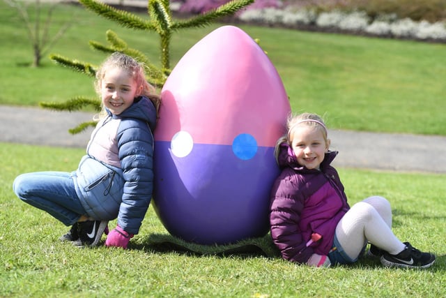 Lani Ellis (aged seven) and her younger sister Mila Ellis (aged four) with one of the giant eggs on display