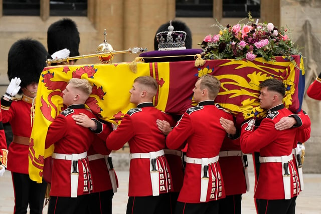The coffin of Queen Elizabeth II with the Imperial State Crown resting on top is carried by the Bearer Party into Westminster Abbey during the State Funeral of Queen Elizabeth II.  (Photo by Christopher Furlong/Getty Images)