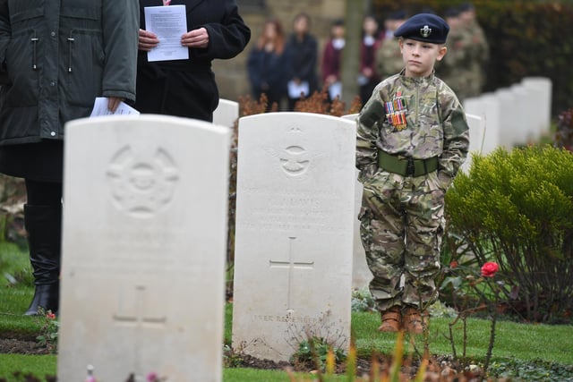 Archie Flintoft (aged seven) in his army uniform and wearing his great grandads medals at the Remembrance service at the Commonwealth War Graves Cemetery
