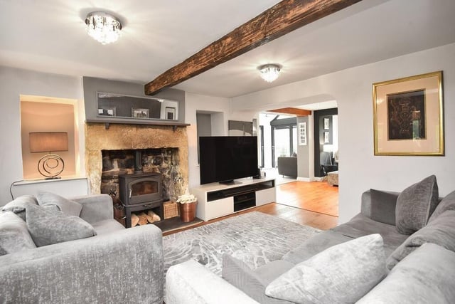 Comfort and touch of resticity in this reception room with stone fireplace and stove.