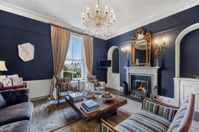 An elegant lounge with feature fireplace, sash windows and solid oak flooring.