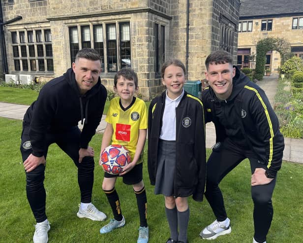 Harrogate Town players Jack Muldoon and Mathew Foulds, with Saint Michael’s CEO, Tony Collins’s grandson, and the daughter of a hospice colleague outside the Crimple House Hospice in Harrogate. (Picture contributed)