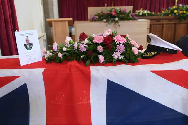 Pictured is Maurice's coffin with Union Jack flag, Naval cap and his golf cap.