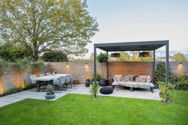 Patio seating areas with gazebo cover within the enclosed rear garden.