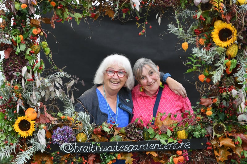Norah Saville and Linda Healey pose for a photo in the floral picture frame in the Grand Floral Pavilion