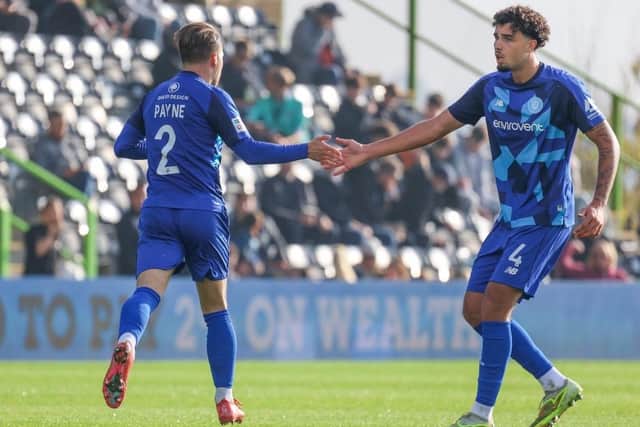 Lewis Payne, left, is congratulated by team-mate Archie Baptiste after netting Harrogate Town's first goal at Forest Green Rovers. Picture: Matt Kirkham
