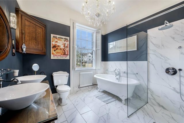 A super stylish, marble tiled bathroom within the property
