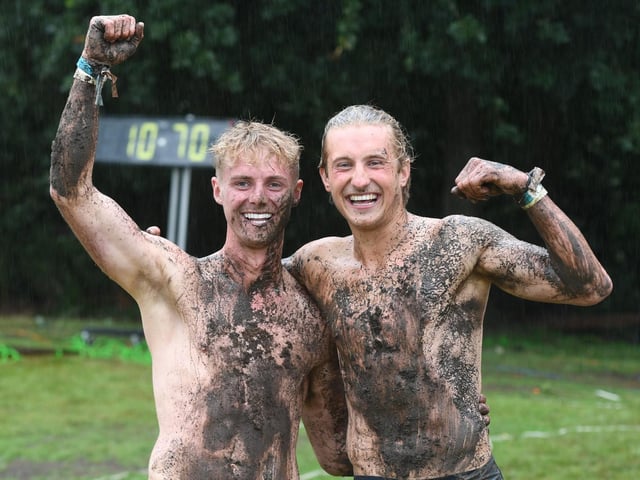 Expert winner Ched Adamski and Novice winner Shaun Spozio covered in mud after winning the Pole Climbing Championships at the show