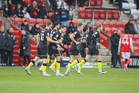 Harrogate Town players celebrate after Josh March headed home and eighth-minute equaliser during their League Two draw at Fleetwood. Pictures: Matt Kirkham