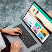 A lady sat with a laptop booking a holiday.