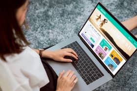 A lady sat with a laptop booking a holiday.