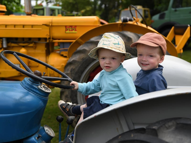 Joe Hannam-Clark (aged one) and his brother Frank (aged three) sat on a tractor in the sunshine at Newby Hall