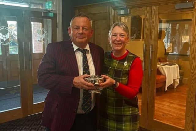 Oakdale GC's Rabbits fixtures secretary Jamie Letts is presented with the Committee Cup by club president Penny Baxter.
